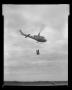 Photograph: [Barrels being carried by cargo sling of XH-40 #3]