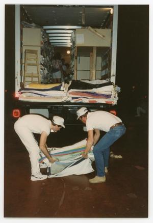 [Two Volunteer Workers Unloading AIDS Memorial Quilts]