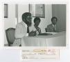 Photograph: [Three Speakers During a Panel Discussion]