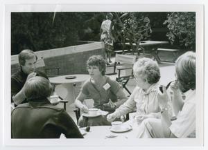 [Group of Five Seated Outside with Cups of Tea]
