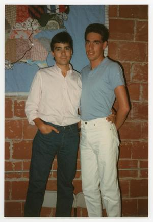 [Two Men Standing Next to AIDS Memorial Quilt Display]