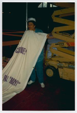 [Woman Holding AIDS Memorial Quilt Panel]