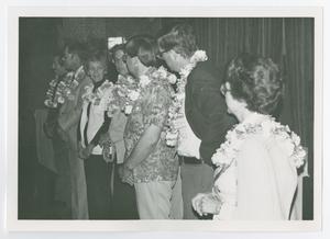[Seven People in a Line Wearing Leis]