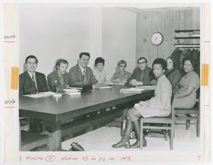 [Group of Men and Women at a Table Pose for Camera]