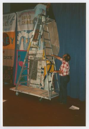 [Two People Setting Up Quilt Panels at the Names Project Tour in Dallas, Texas]