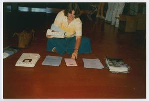 [Woman Seated on Floor Organizing Fliers for Names Project Tour]