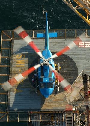[A blue helicopter on a helipad]