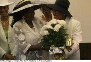[Two women holding flower pot, 2]