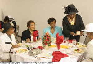 [Several women sitting at luncheon]