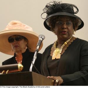 [Two women standing in front of a microphone, 2]