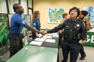 [Police officers shake student's hand the LGBTQIA Career Fair, 3]