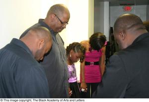 [Rachel Webb, Kirondria Woods, Curtis King, and several other praying in hallway]