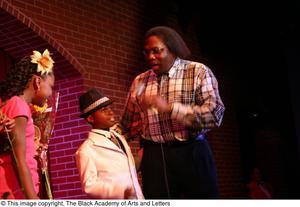 [Kirondria Woods, Rachel Webb, boy in white suit, and Curtis King on stage]