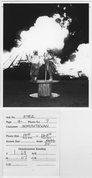 [Mascot and student performing at North Texas Homecoming bonfire activities, c. 1980]
