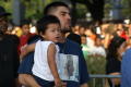 Photograph: [Parent holds child during a back to school fair in Dallas, Texas]
