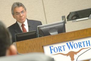 [Jose Legaspi standing behind podium with "Fort Worth" sign]