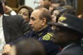 Photograph: [Officer of the Dallas County Sheriff's Office listening]