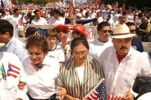 [Immigration Protesters Marching With Signs and American Flags]