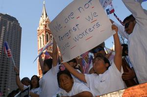 [Protesters with signs and flags outside of Cathedral Santuario de Guadalupe]