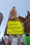 Primary view of [Female protester with sign next to Cathedral Santuario de Guadalupe in Dallas]
