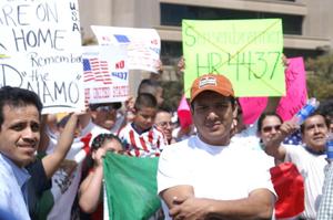 Primary view of object titled '[Protesters carry signs and a Mexican flag]'.