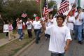 Photograph: [Group of Protesters of All Ages Walking With Flags and Signs]