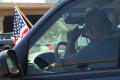 Photograph: [Man in car photographing protesters]