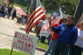Thumbnail image of item number 1 in: '[Protesters with large sign and American flag]'.