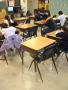 Photograph: [Empty desks show the number of absent students in a classroom]