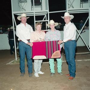 Primary view of object titled '[Four people in Youth division award presentation at Will Rogers Coliseum]'.