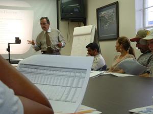 Primary view of object titled '[Jorge Suarez Conducting Training Course]'.