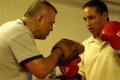 Thumbnail image of item number 1 in: '[Boxing instructor with student]'.
