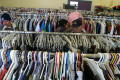 Primary view of [People look through the clothing at Dallas Catholic Charities]