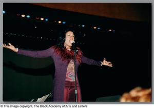 Primary view of object titled '[Tanya Blount holds out arms while singing]'.