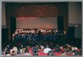 Photograph: [Choir and musicians performing on stage]